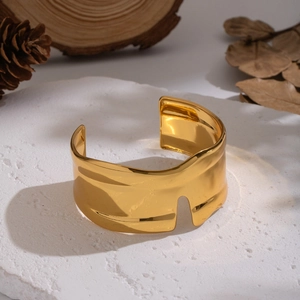 Minimalist wide geometric open cuff bracelet in gold finish with wavy abstract texture