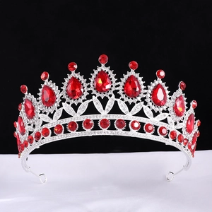 Baroque bridal crown with red pear-shaped crystals and silver filigree on a black background