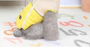 Detail of dog winter vest featuring yellow beige patchwork and zipper closure