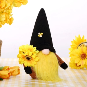 Detailed view of harvest gnome with yellow beard holding a sunflower for home decor