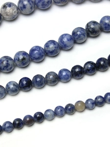 Macro shot of blue and white spotted natural stone beads for jewelry making