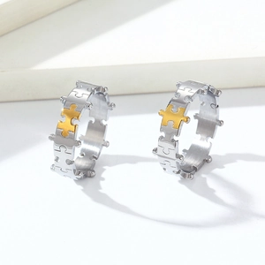 Macro detail of jigsaw puzzle titanium steel rings with a single gold puzzle piece accent