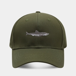 Detailed embroidery of a shark on the olive green cotton twill baseball cap fabric