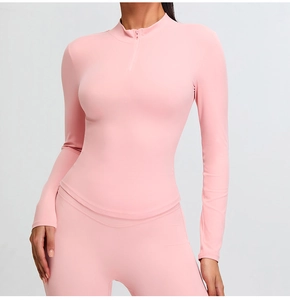 Detail of pink half-zip yoga top fabric with high-stretch seams and soft athletic texture