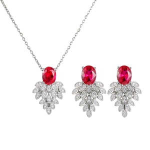 Detailed set of silver necklace and earrings with oval red gems and zircon leaf motifs
