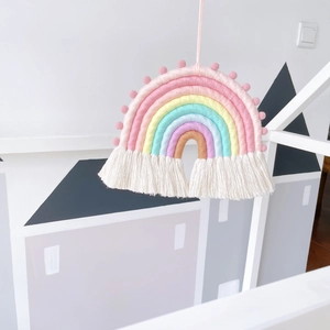 Handwoven rainbow wall hanging with pastel yarn ropes and soft cream fringe tassels