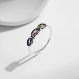 Vintage S925 sterling silver ring with three oval multi-color crystals on a white background