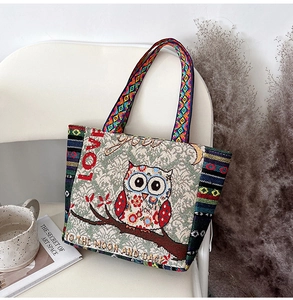 Detail of owl embroidery and 'Love to the Moon' text on a thick canvas tote bag