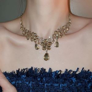 Champagne crystal flower teardrop pendant necklace set on model's neck for elegant look