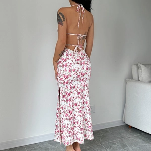 Floral backless halter dress featuring a side slit and elegant pink flower pattern