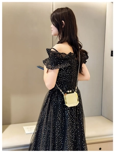 Golden hexagonal acrylic clutch bag with thin chain strap shown with a sequin evening dress