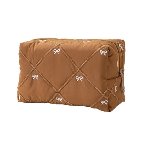Caramel quilted makeup bag with elegant bow embroidery and metallic zipper closure