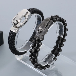 Close-up of punk leather bracelet with lion head and skull charms on display