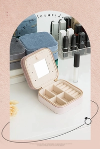 Detailed interior of pink velvet jewelry box with mirror, earring slots and ring storage