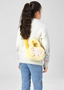 Close-up of cute unicorn embroidery on soft yellow plush crossbody bag for kids