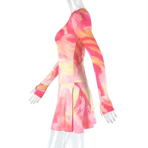 Detail of two-piece set featuring pink yellow watercolor print and pleated mini skirt
