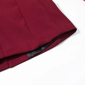 Detailed close-up of wine red blazer with high-quality stitching and smooth black lining