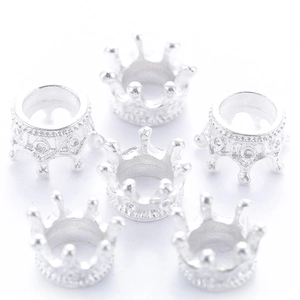 Close-up of silver crown alloy charms for DIY jewelry making on white background