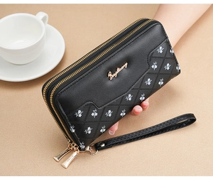 Close-up of black PU leather wallet with diamond quilted pattern and small white flowers