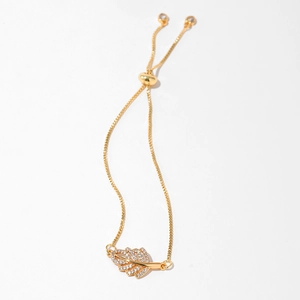 Macro detail of gold adjustable box chain with zircon leaf pendant and sliding bead clasp