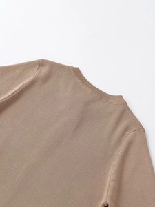 Close-up of khaki knit sweater showing ribbed crew neck collar and fine fabric texture