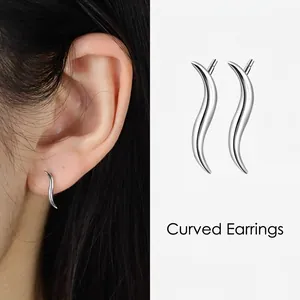 Minimalist S925 sterling silver curved line stud earrings shown on model and white base