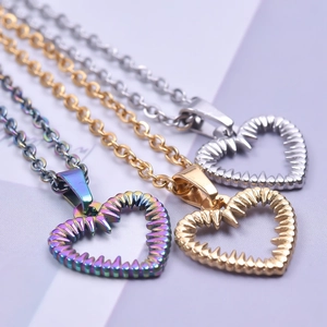 Three minimalist heart pendant necklaces in rainbow, gold, and silver stainless steel
