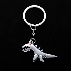 Detailed view of silver metal dinosaur keychain with movable joints and red star detail