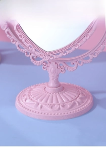 Close-up of the stable pink heart-shaped desktop makeup mirror with a wide round base