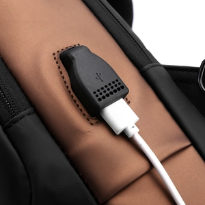 Close-up of the built-in USB charging port on the side of a waterproof chest bag