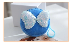 Close-up of bright blue plush round coin purse with shiny sequin bow and plastic hook