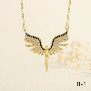Detail of golden angel wing pendant with black and white pavé cubic zirconia inlay