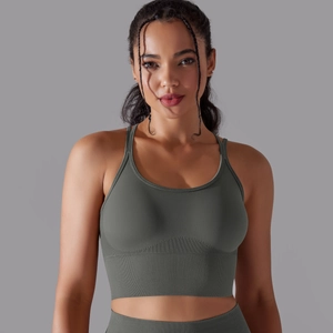 Detail of dark green seamless ribbed sports bra with wide supportive waistband