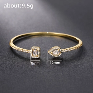 Elegant gold-plated brass open bracelet with cubic zirconia charms, weight 9.5g