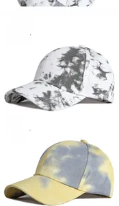 Close-up of tie-dye cotton baseball caps in black-white and yellow-grey patterns