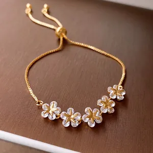 Adjustable gold plated flower bracelet with star shaped zircon charms on classic chain