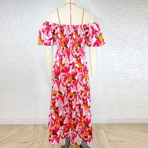 Detailed back view of a strapless floral maxi dress with tiered ruffles and abstract print