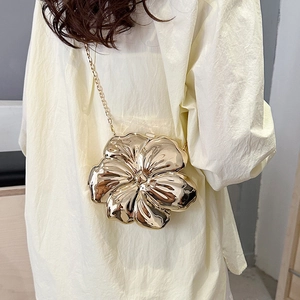 Artistic gold flower-shaped metal clutch bag with petal details and fine chain strap