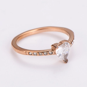Detail view of heart-shaped zircon ring with rose gold plating and side stones