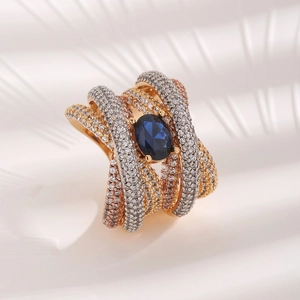Tricolor interlocking zircon ring with oval blue gemstone center in elegant micro shot