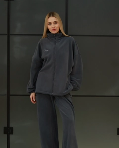 Detail of dark gray polar fleece two-piece set featuring soft fabric texture and embroidery