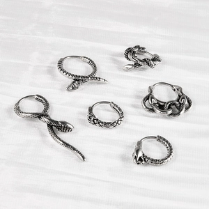 Detail of vintage silver snake earrings set in stainless steel with textured scales