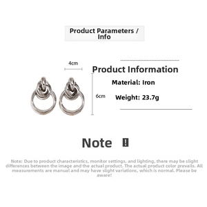 Detailed view of silver knot double hoop earrings with a polished metallic finish