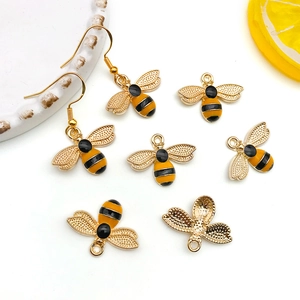 Detailed view of yellow bee alloy pendants and earrings for DIY jewelry making