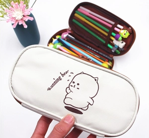 Detail of bear stationery pouch showing multiple internal pen slots and durable canvas