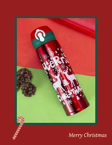 Detail of red Christmas thermos featuring reindeer patterns and Merry Christmas text