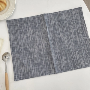 Close-up of rectangular cotton linen placemat with blue and white vertical stripes