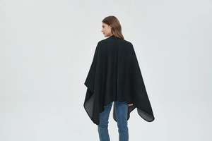 Back view of black faux cashmere shawl showing the split hem and professional stitched edge