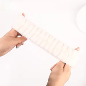 Detail showing the high elasticity of the white coral fleece headband for skincare