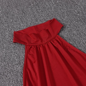 Detail of red halter neckline showing silky fabric with subtle sheen and fine pleating